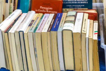 CESENA, ITALY - NOVEMBER 18, 2018: lights are enlightening old books for sale in Antiques Fairのeditorial素材