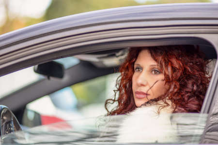 woman smiles driving a carの写真素材