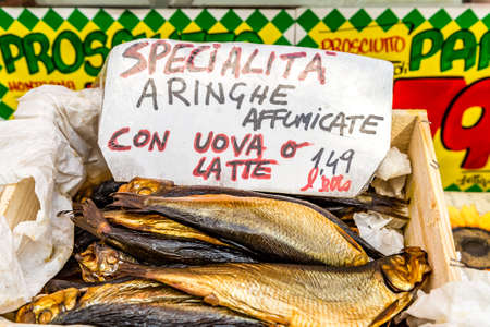 ROME, ITALY - JANUARY 2, 2019: light is enlightening signboard of smoked herrings for sale