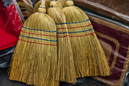Brooms of sorghum for sale in a hardware store