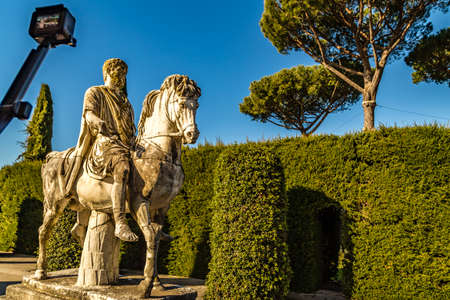 CASTEL GANDOLFO (ROME), ITALY - JANUARY 3, 2019: tourist is shooting video of equestrian statue with action cam  in gardens of Villa Barberini in Castel Gandolfoのeditorial素材