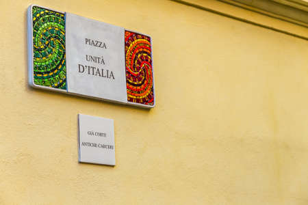 RAVENNA, ITALY - JANUARY 15, 2019: light is enlightening  street name sign of Piazza Unita Italiaのeditorial素材