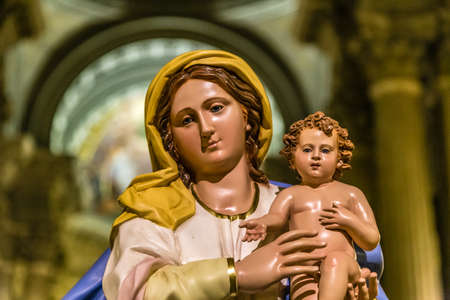 ROME, ITALY - JANUARY 5, 2019: light is enlightening statue of The Blessed Virgin Mary holding Baby Jesus in Basilica of Saint Mary in Portico in Campitelliのeditorial素材