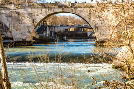 ROME, ITALY - JANUARY 4, 2019: waters of Tiber river is flowing under ancient bridgeのeditorial素材