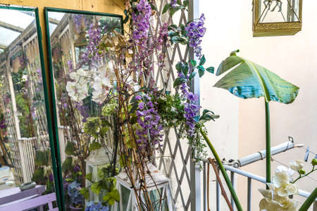 decorations with plastic flowers and real plants in Italian terrace in a winter dayの写真素材