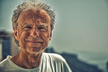Closeup of mature man with grey hair and three days beard