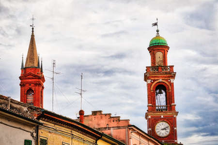 clock tower and colorful buildings in ancient hamlet of Italian villageの写真素材