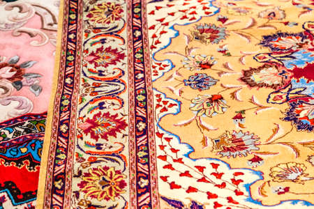 CESENA, ITALY - NOVEMBER 18, 2018: lights are enlightening ancient Eastern rugs for sale in Antiques Fairのeditorial素材