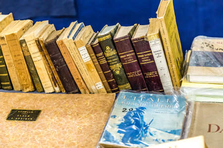 CESENA, ITALY - NOVEMBER 18, 2018: lights are enlightening old books for sale in Antiques Fairのeditorial素材