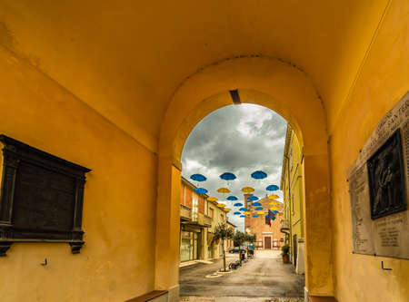 SANT AGATA SUL SANTERNO (RA) - FEBRUARY 2, 2019: blue and yellow umbrellas hanging to decorate the square during the celebrations of the day of Saint Agathaのeditorial素材