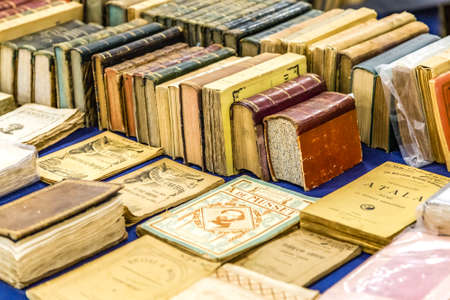 CESENA, ITALY - NOVEMBER 18, 2018: lights are enlightening old books for sale in Antiques Fairのeditorial素材