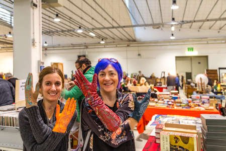 CESENA, ITALY - NOVEMBER 18, 2018: women showing artistic gloves in Antiques Fair