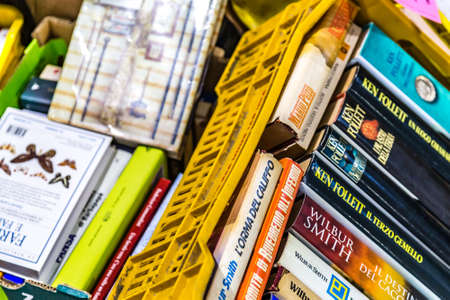 CESENA, ITALY - NOVEMBER 18, 2018: lights are enlightening old books for sale in Antiques Fairのeditorial素材