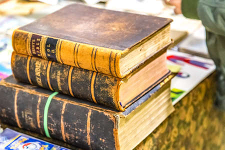 CESENA, ITALY - NOVEMBER 18, 2018: lights are enlightening old Holy Bible books for sale in Antiques Fairのeditorial素材