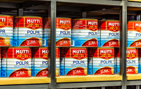 BOLOGNA, ITALY - DECEMBER 16, 2018: lights are enlightening cans of finely chopped tomatoes by Mutti at FICO Eataly World, the largest gourmet agri-food park in the worldのeditorial素材