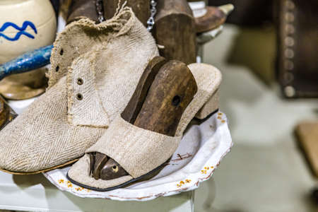 CESENA, ITALY - NOVEMBER 18, 2018: lights are enlightening old shoes for sale in Antiques Fair