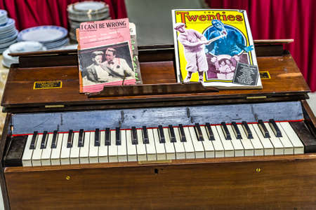 CESENA, ITALY - NOVEMBER 18, 2018: lights are enlightening old piano for sale in Antiques Fairのeditorial素材