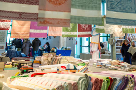 CESENA, ITALY - JANUARY 20, 2019: lights are enlightening fabrics for sale in Antiques Fairのeditorial素材