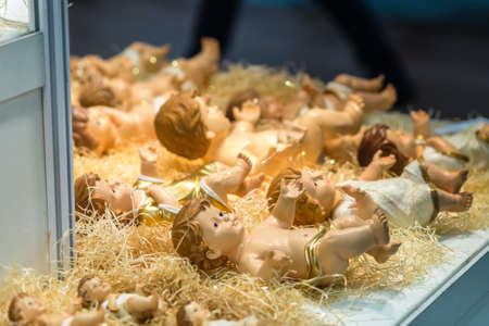 BOLOGNA, ITALY - FEBRUARY 18, 2019: lights are enlightening statues of Baby Jesus at stand in DEVOTIO Religious products and service exhibitionのeditorial素材