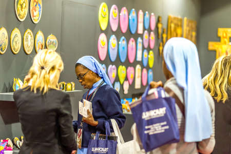 BOLOGNA, ITALY - FEBRUARY 18, 2019: Booth presenter talking with visitor at stand of EGIM in DEVOTIO Religious products and service exhibitionのeditorial素材