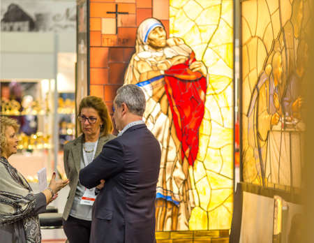 BOLOGNA, ITALY - FEBRUARY 18, 2019: Booth presenter talking with visitor at stand of MELLINI in...