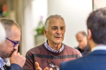 BOLOGNA, ITALY - FEBRUARY 18, 2019: Booth presenter talking with visitor at stand of ANGELO AREZZO SAS in DEVOTIO Religious products and service exhibitionのeditorial素材