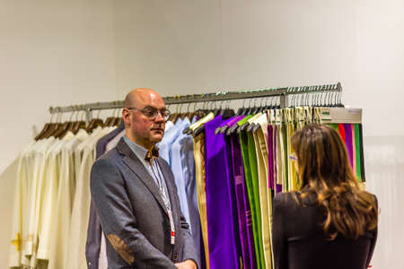 BOLOGNA, ITALY - FEBRUARY 18, 2019:  Booth presenter talking with visitor at stand of PANAROTTO in DEVOTIO Religious products and service exhibitionのeditorial素材