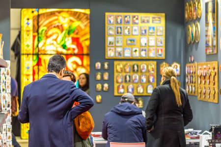 BOLOGNA, ITALY - FEBRUARY 18, 2019: Booth presenter talking with visitor at stand of EGIM in DEVOTIO Religious products and service exhibitionのeditorial素材