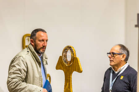BOLOGNA, ITALY - FEBRUARY 18, 2019:  Booth presenter talking with visitor at stand of ARTE SACRA MERENDONI in DEVOTIO Religious products and service exhibitionのeditorial素材