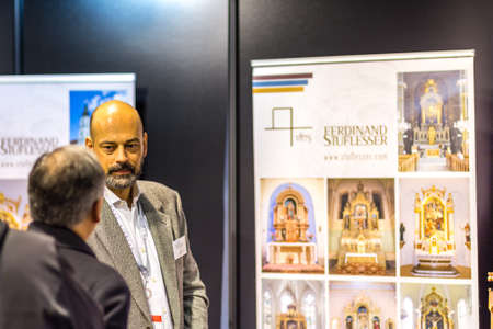 BOLOGNA, ITALY - FEBRUARY 18, 2019: Booth presenter talking with visitors at stand of  FERDINAND STUFLESSER in DEVOTIO Religious products and service exhibitionのeditorial素材