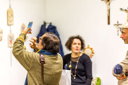 BOLOGNA, ITALY - FEBRUARY 18, 2019: booth presenter talking with visitor at stand of ANGELI in DEVOTIO Religious products and service exhibitionのeditorial素材