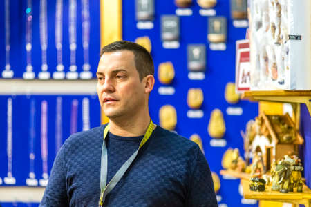 BOLOGNA, ITALY - FEBRUARY 18, 2019: booth presenter waiting for visitors at stand of NEUMEYER in DEVOTIO Religious products and service exhibitionのeditorial素材