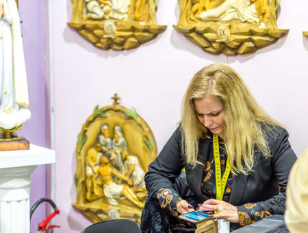 BOLOGNA, ITALY - FEBRUARY 18, 2019: booth presenter waiting for visitors at stand of  BAROCK STIL in DEVOTIO Religious products and service exhibitionのeditorial素材
