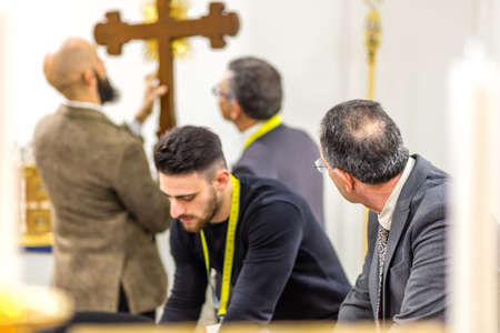 BOLOGNA, ITALY - FEBRUARY 18, 2019: booth presenter talking with visitor at stand of ALBRIZZI GIUSEPPE in DEVOTIO Religious products and service exhibitionのeditorial素材