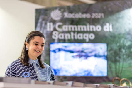BOLOGNA, ITALY - FEBRUARY 18, 2019: booth presenter waiting for visitors at stand of  Way of Saint...
