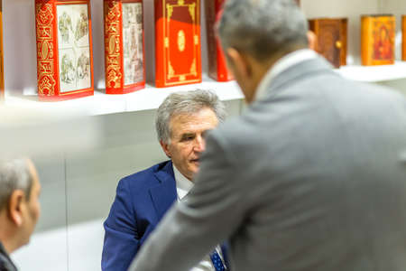 BOLOGNA, ITALY - FEBRUARY 18, 2019: booth presenter talking with visitor at stand of SICOM in DEVOTIO Religious products and service exhibitionのeditorial素材