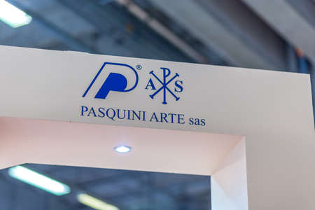 BOLOGNA, ITALY - FEBRUARY 18, 2019: lights are enlightening PASQUINI ARTE logo on signboard on stand in DEVOTIO Religious products and service exhibitionのeditorial素材