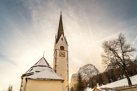 Catholic church in Alpine snowy panoramaの写真素材