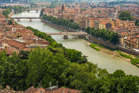 Amazing panorama of the Adige River running along ancient buildings of Verona, Italyの写真素材
