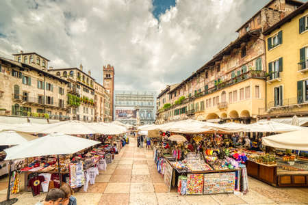 VERONA (VR), ITALY - MAY 10, 2019: tourists visiting the famous Piazzale delle Erbe, Herbs Square, and its typical market in Veronaのeditorial素材