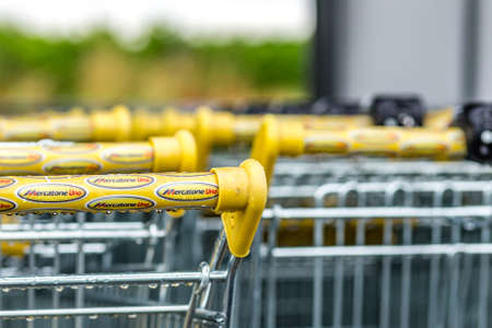 RUSSI (RA), ITALY - MAY 27, 2019: sunlight is enlightening and raindrops are covering the logo of Mercatone Uno on shopping carts on a gloomy day. Company went bankrupt last weekのeditorial素材