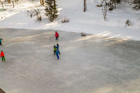 BADIA (BZ), ITALY - FEBRUARY 9, 2019: Boys and girls have fun skating on the ice in the Dolomitesのeditorial素材