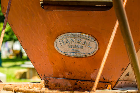 ALFONSINE (RA), ITALY - MAY 16, 2019: sunlight is enlightening a very old threshing machine by MANSAL Legnago at Sagra delle Alfonsine Country Festival in Italyのeditorial素材