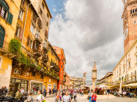 VERONA (VR), ITALY - MAY 10, 2019: tourists visiting the famous Piazzale delle Erbe, Herbs Square, and its typical market in Veronaのeditorial素材
