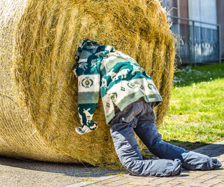 ALFONSINE (RA), ITALY - MAY 16, 2019: sunlight is enlightening dummy with head stuck in round hay bale at Sagra delle Alfonsine Country Festival in Italyのeditorial素材