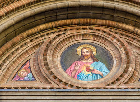 BOLOGNA, ITALY - MAY 10, 2019: sunlight is enlightening mosaic on facade of the Catholic Church of The Sacred Heart of Jesus in Bolognaのeditorial素材