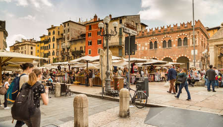 VERONA (VR), ITALY - MAY 10, 2019: tourists visiting the famous Piazzale delle Erbe, Herbs Square, and its typical market in Veronaのeditorial素材
