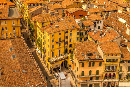 VERONA (VR), ITALY - MAY 10, 2019: sun is enlightening the roofs ot the ancient buildings of Verona in Italyのeditorial素材