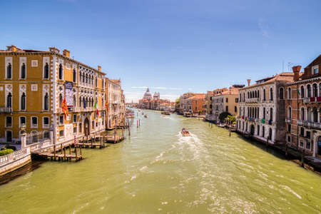 VENEZIA, ITALY â MAY 31, 2019: tourists visiting the city and enjoying the view of boats passing in Canal Grande main channel of Venice,  from bridge Ponte dell'Accademiaのeditorial素材