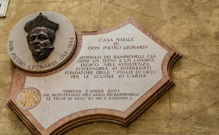 VERONA (VR), ITALY - MAY 10, 2019: sunlight is enlightening the board on the birth house of Don Pietro Leonardi in Veronaのeditorial素材